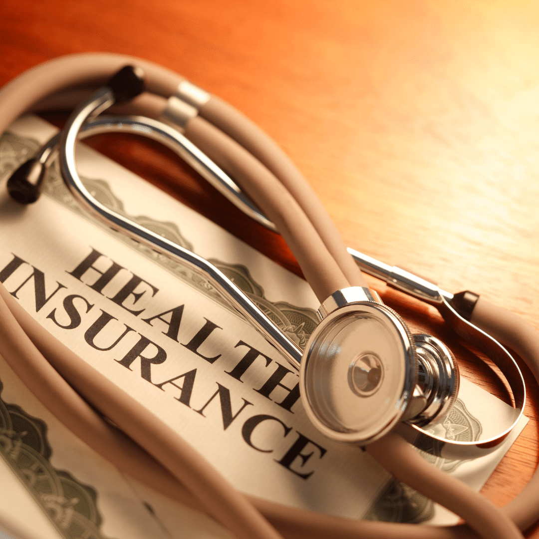 Health Insurance document and a stethoscope on it